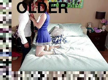 A horny redheaded cheerleader gets some dick from an older guy