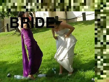 Bride and Maid of Honor Getting Wet With Champagne On The Wedding Day