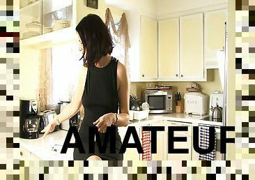 Amateur chick in reality film smoking on top of the kitchen counter