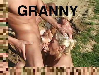 Granny sluts in the mud sucking cock and getting fucked in group sex