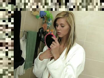 Slim blonde Sindy Vega plays with her shaved pussy in a bathroom