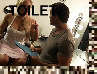 Slut kneels at the bathroom gloryhole and sucks off a dick