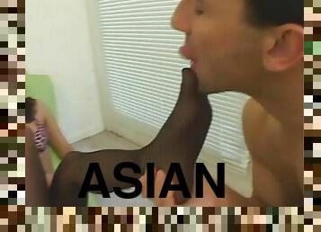 Asian gives him a black stockings footjob