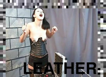 Leather girl turns up the electro pain for her tits