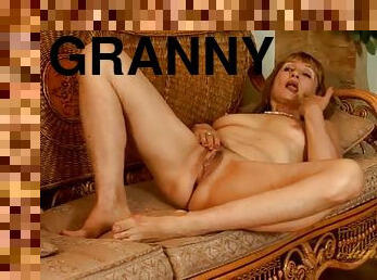 Stripping and dancing granny plays with her cunt