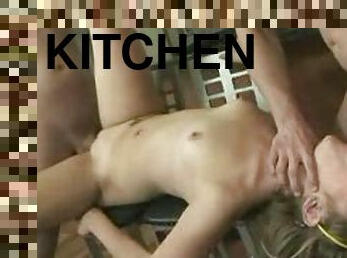 Chick takes two cocks in the kitchen