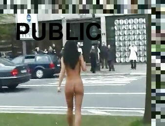 Girl walks around busy city streets naked