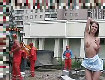 Leggy chick shows body to construction workers