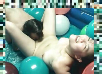 Pigtailed lesbians in pool filled with balloons
