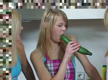 Three horny girls share a massive vegetable during a kitchen orgy