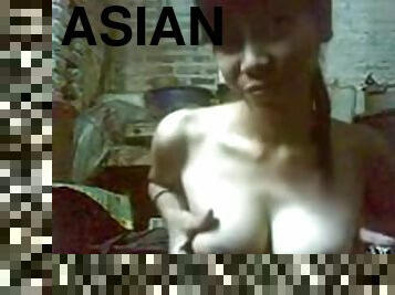 Indonesian girl shows her jugs for the camera and pleasures her pussy