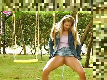 Blonde Girl Peeing While She's On The Swings.