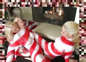 Painter girls play with each others pussies under a Christmas tree