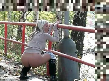 Girl on a stroll takes a piss in public