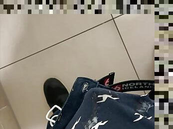 boy is wanking in mall stall bathroom