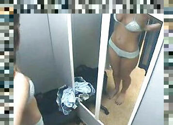 Girl in dressing room trying things on