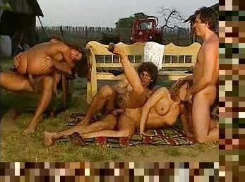 Retro orgy outdoors as sun sets