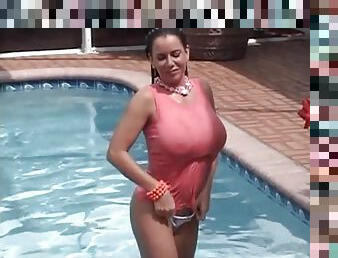 Big tits brunette girl swims in the pool