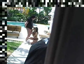 Big tit brunette gets caught sucking a hard cock outside by the pool.