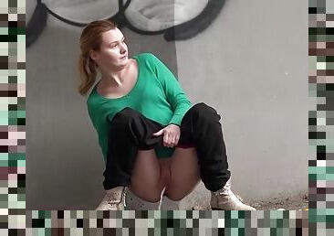 Pissing girl squats by the highway