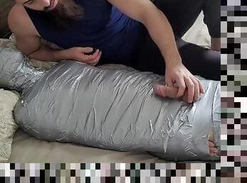 bearded dom using mummified boy as a toy