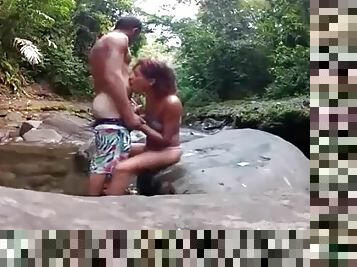 Amateur couple fucks on a rock in the river