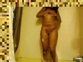 A salacious ebony girl dances nude in the bathroom