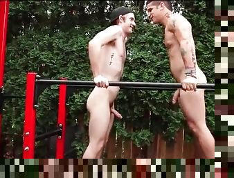 Athletic young guys suck dick outdoors