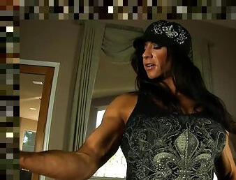 Beefy Milf shows us her muscles then her big clit and dildos