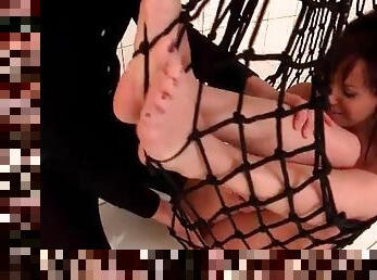 Teen girl caught in a net and sucking dick