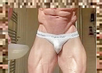 Young bodybuilder posing in jockstraps