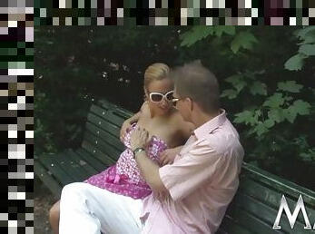 Guy fucks seductive blonde on a bench in the park