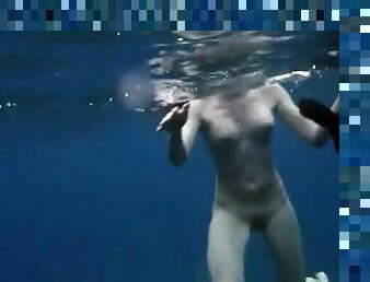 Beautiful girls swim naked in the deep ocean