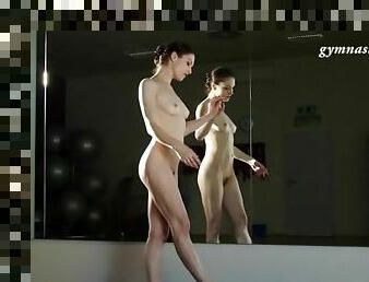 Ballerina stretches naked in front of mirror