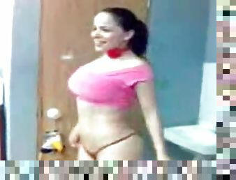 Big-breasted Latina babe goofs around walking naked