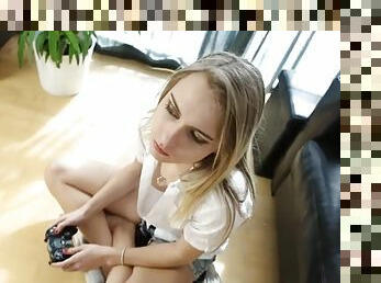Video gaming girl in a sexy white blouse