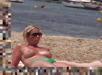 Spying on a beach milf with great tits