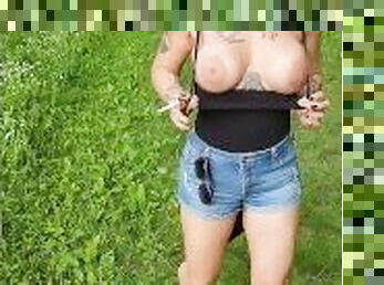 Out in the woods, smoking a cigarette and letting those massive tits free