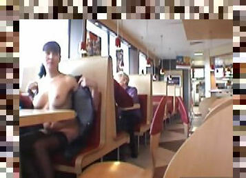 Young brunette flashes her boobs in the restaurant