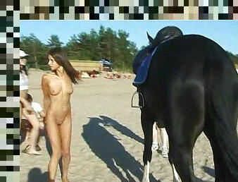 Naked teen riding a horse at the beach turns heads
