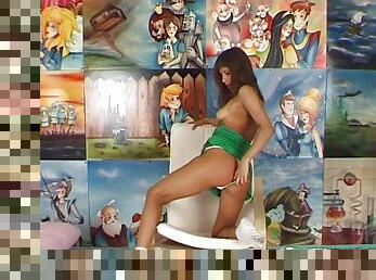 Cartoon characters on the wall get to see a hottie dildoing herself