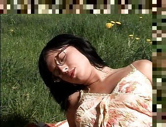 Girl in nerdy glasses has fantastic anal sex in a grassy field