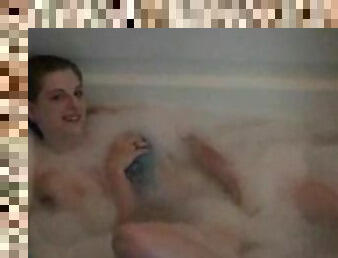 Babe in the tub masturbates her pussy