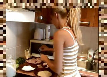 Pretty blonde Sophie Moone cooks breakfast in the kitchen