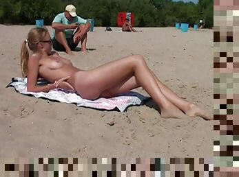 Nudist girls have fun with each other at the beach