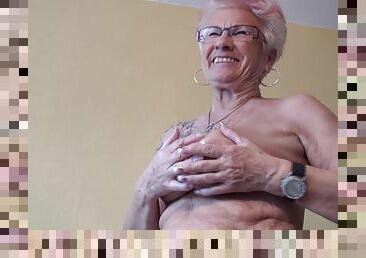 Tattooed granny exposes her big clit for your pleasure