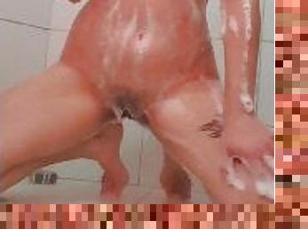 Naughty girl soaping up in the shower showing off her sensuality