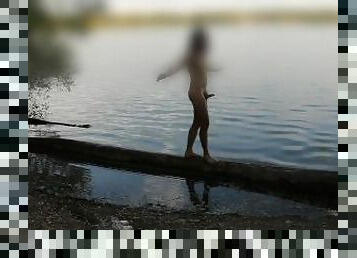 Naked young man at the lake