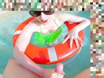 Beautiful busty redhead mature is out in the pool in her green bikini