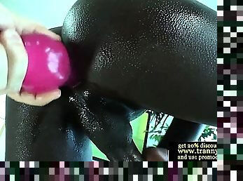 Black tranny tugs cock and toys her ass
